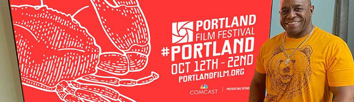 Portland Film Festival volunteer in front of screen